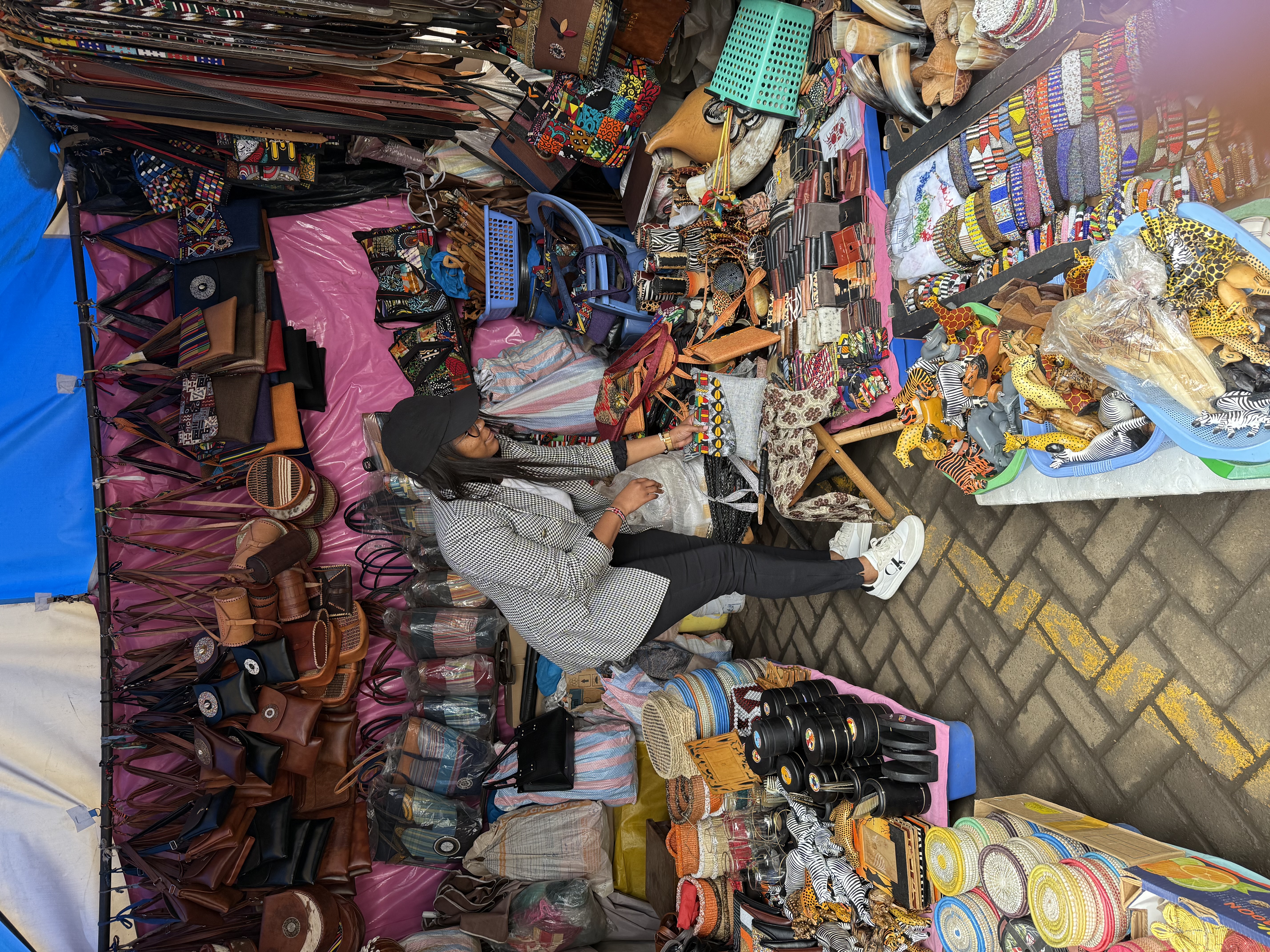 Browsing handmade leather goods and crafts at a Nairobi market stall